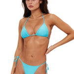 Woman wearing a blue bikini against a white background