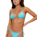 Woman wearing a blue bikini against a white background