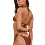 Woman wearing a brown bikini with a white background