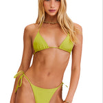 Woman wearing a green bikini set on a white background