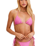 Woman wearing a pink bikini on a white background