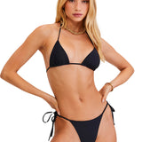 Woman wearing a black bikini set on a white background