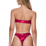 Woman wearing a pink bikini on a white background