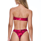 Woman wearing a pink bikini on a white background