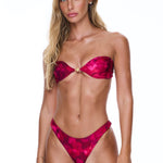 Woman wearing a red bikini against a white background