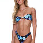 Woman wearing a floral bikini on a white background