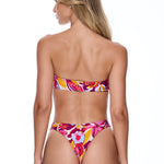 Woman wearing a colorful floral bikini on a white background