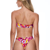 Woman wearing a colorful floral bikini on a white background