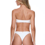 Woman wearing a white bikini on a white background