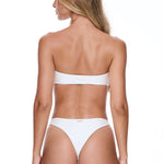 Woman wearing a white bikini on a white background