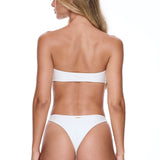 Woman wearing a white bikini on a white background